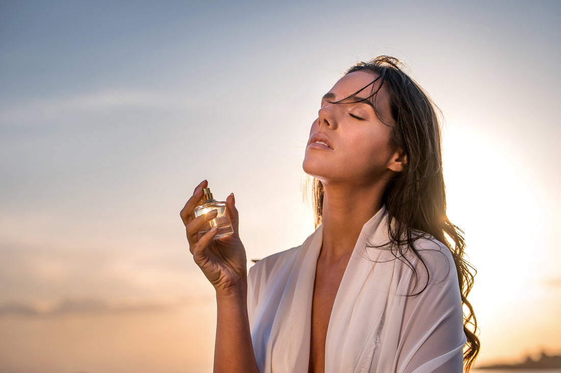 A woman uses the Delos eau de parfume.