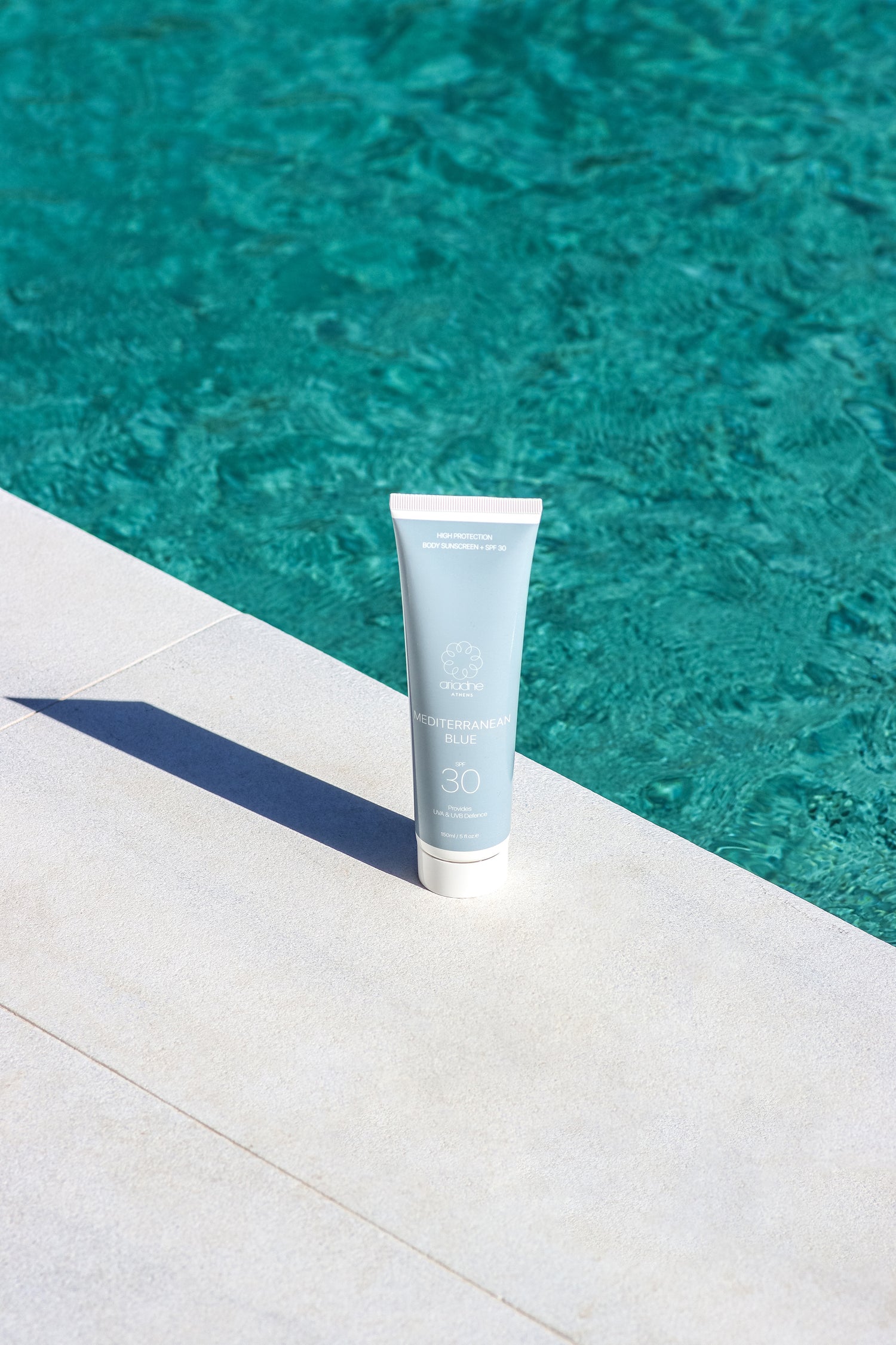 The Mediterranean Blue Sunscreen SPF30 near the pool.